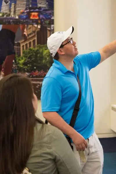 A Chicago Greeter talks to visitors in a visitor center.