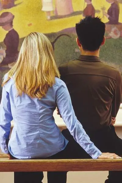 Couple staring at a painting 