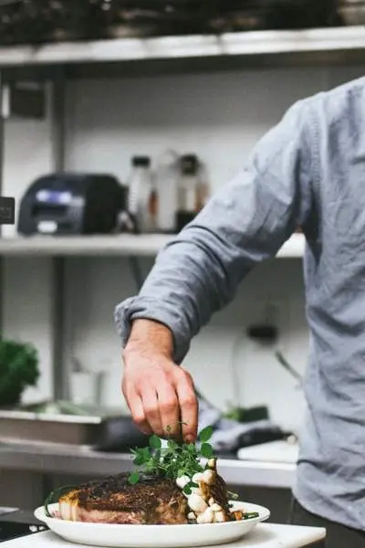 A chef plating up a restaurant style meal 