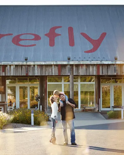 The owners of Firefly Grill stand in front of their establishment