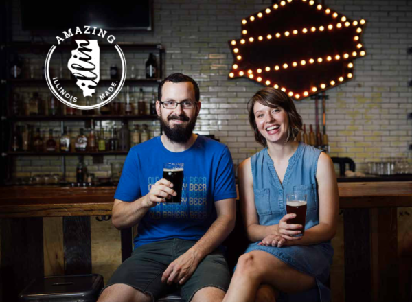 A couple holding up a pint of beer.