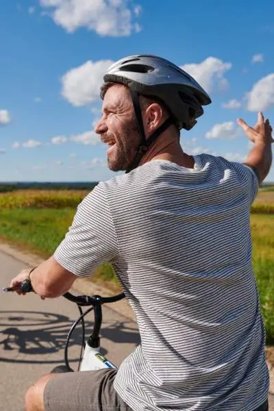 A couple riding bicycles on a rural road