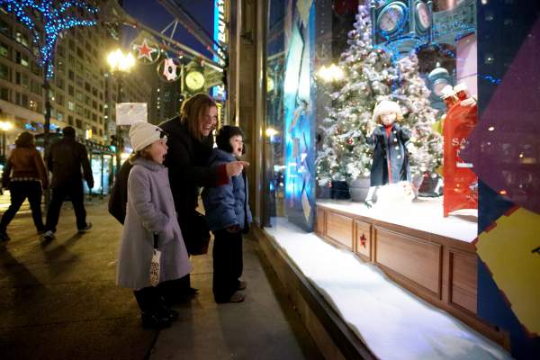 Woman and kids looking outside in to window display